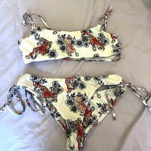 A small SHEIN bikini that is white with tigers on it. Great fit. Minimal use.
